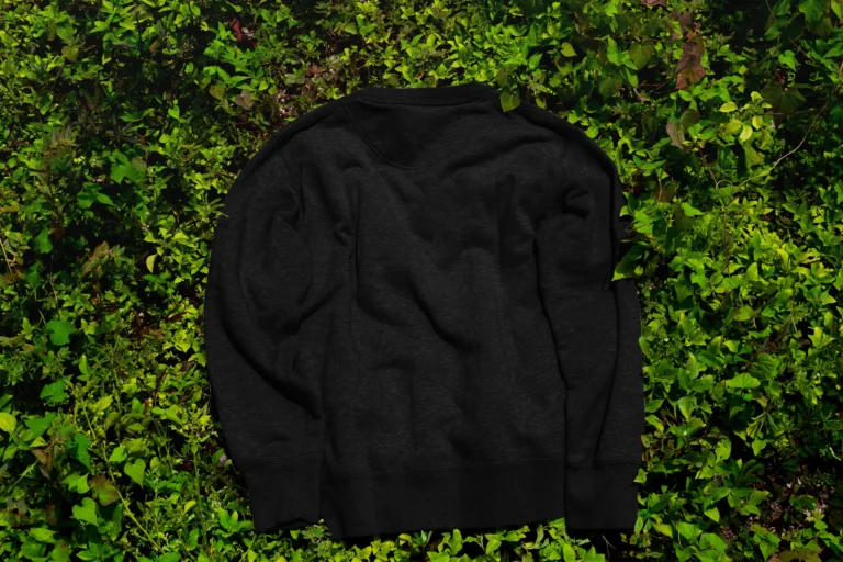 Black oversized sweatshirt lying on the grass