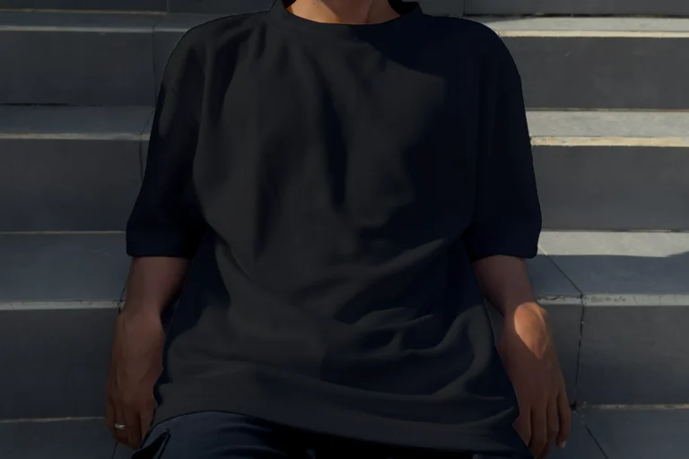 Half sleeve black crewneck t-shirt worn by model in close up sitting on stairs